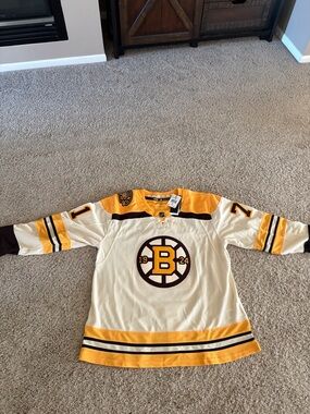 adidas Boston Bruins Cream and Gold Alternate Hockey Jersey.